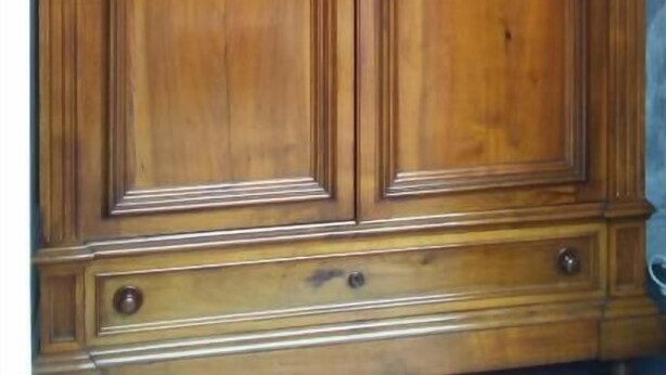 A large wooden wardrobe with two doors, a decorative top, and a base with handles. - Animosa Suite (Castiglione di Sicilia)