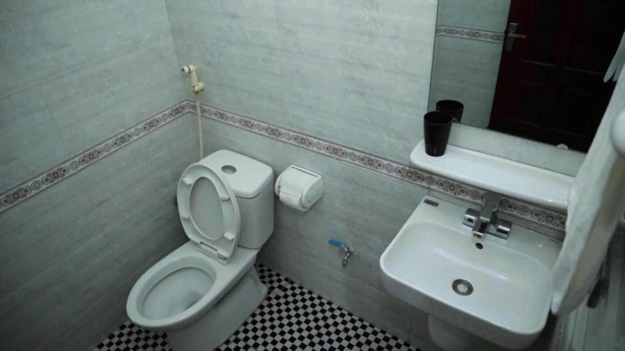 Un bagno piccolo con il water, un lavandino e uno specchio.