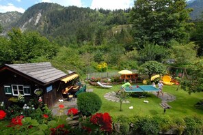 A rustic cabin with a garden, a ping pong table, and a children's play area with a slide. - Maple view in the Tasser house (Mayrhofen)