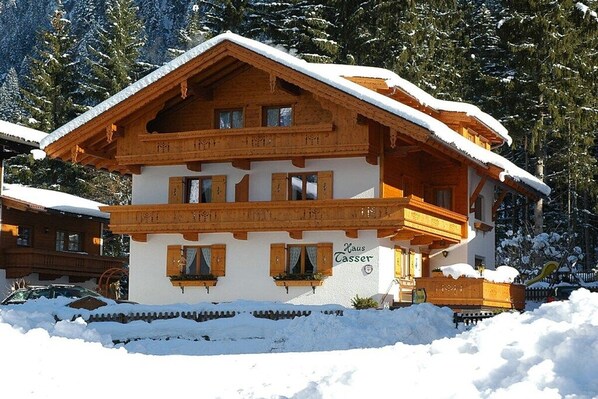 A traditional chalet with a wooden facade, multiple balconies, and a sign indicating 'Haus Tasser'. - Maple view in the Tasser house (Mayrhofen)