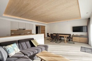 Ein stilvoller Wohnraum mit Sofa, Esstisch und Fernseher.