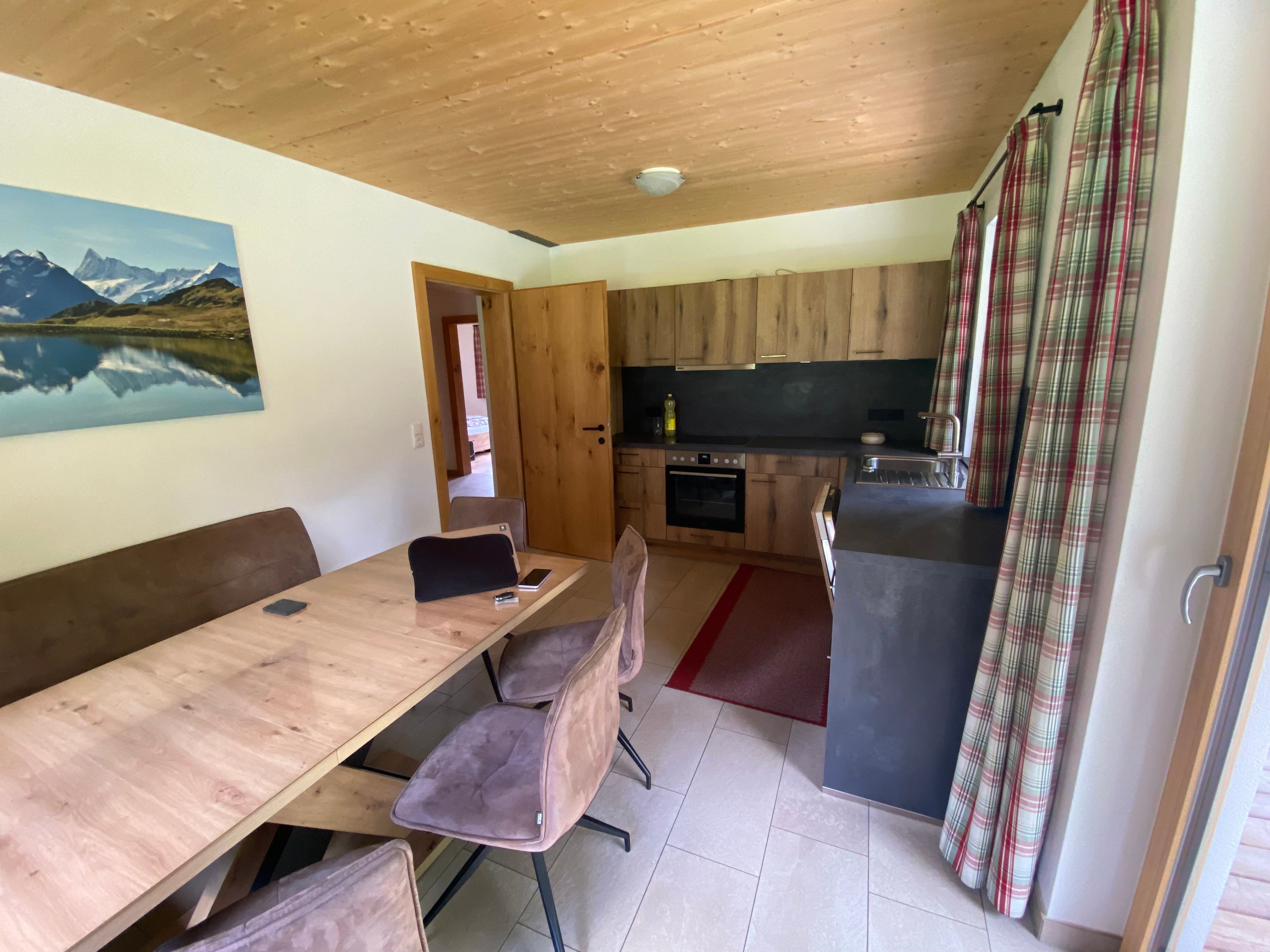 A compact kitchen with wooden cabinets, a built-in oven, and a small countertop.