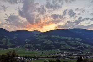 A panoramic view of a valley with a town nestled among rolling hills. - Apartment Steinberger (Ramsau im Zillertal)