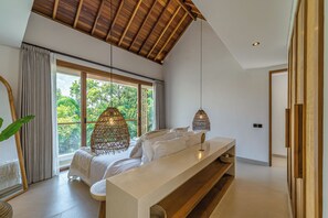 A modern bedroom with a large window, a bed, a bedside table, and a hanging light fixture. - Villa Paraiso (Umalas)