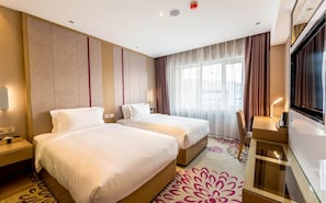 A hotel room with two beds, a TV, a desk, and a large window with curtains. - Lavande Hotels Harbin Railway Station Zhanqian Square (Harbin)