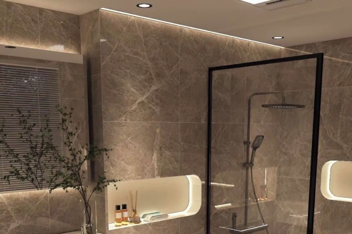 A modern bathroom with a glass-enclosed shower, a vanity with a mirror, and a toilet.