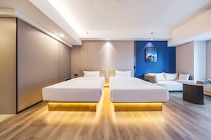 Una habitación de hotel moderna con una cama grande, un sofá y un escritorio.
