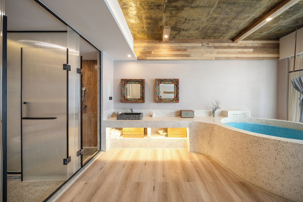 A modern bathroom with a freestanding bathtub, a glass shower enclosure, and a vanity with a sink.