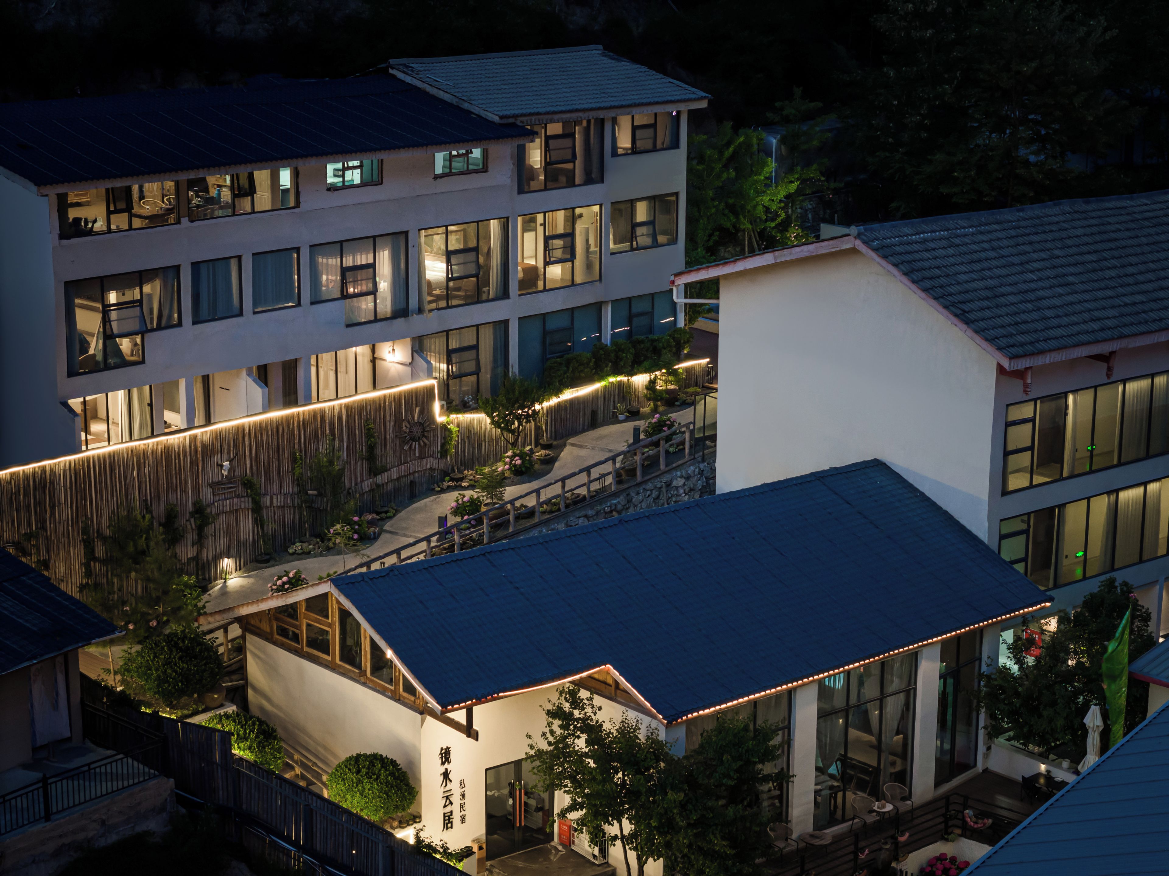 A multi-story building with a modern design, featuring large windows and a well-lit exterior.