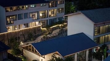 A multi-story building with a modern design, featuring large windows and a well-lit exterior.