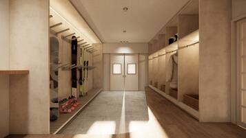 A hallway with a shoe rack, a mirrored closet, and a double door.