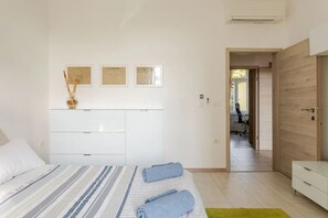 A bedroom with a bed, a dresser, and a desk with a chair. There are three framed certificates on the wall. - Apartments Morski Svet Portorož (Piran)