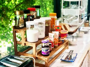 A coffee station with various coffee products and a milk dispenser.