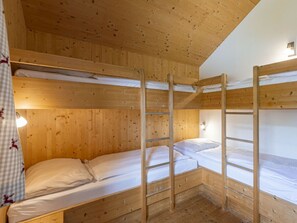A bunk bed room with wooden walls and a ladder. - One-bedroom Cabin (Sankt Georgen am Kreischberg)