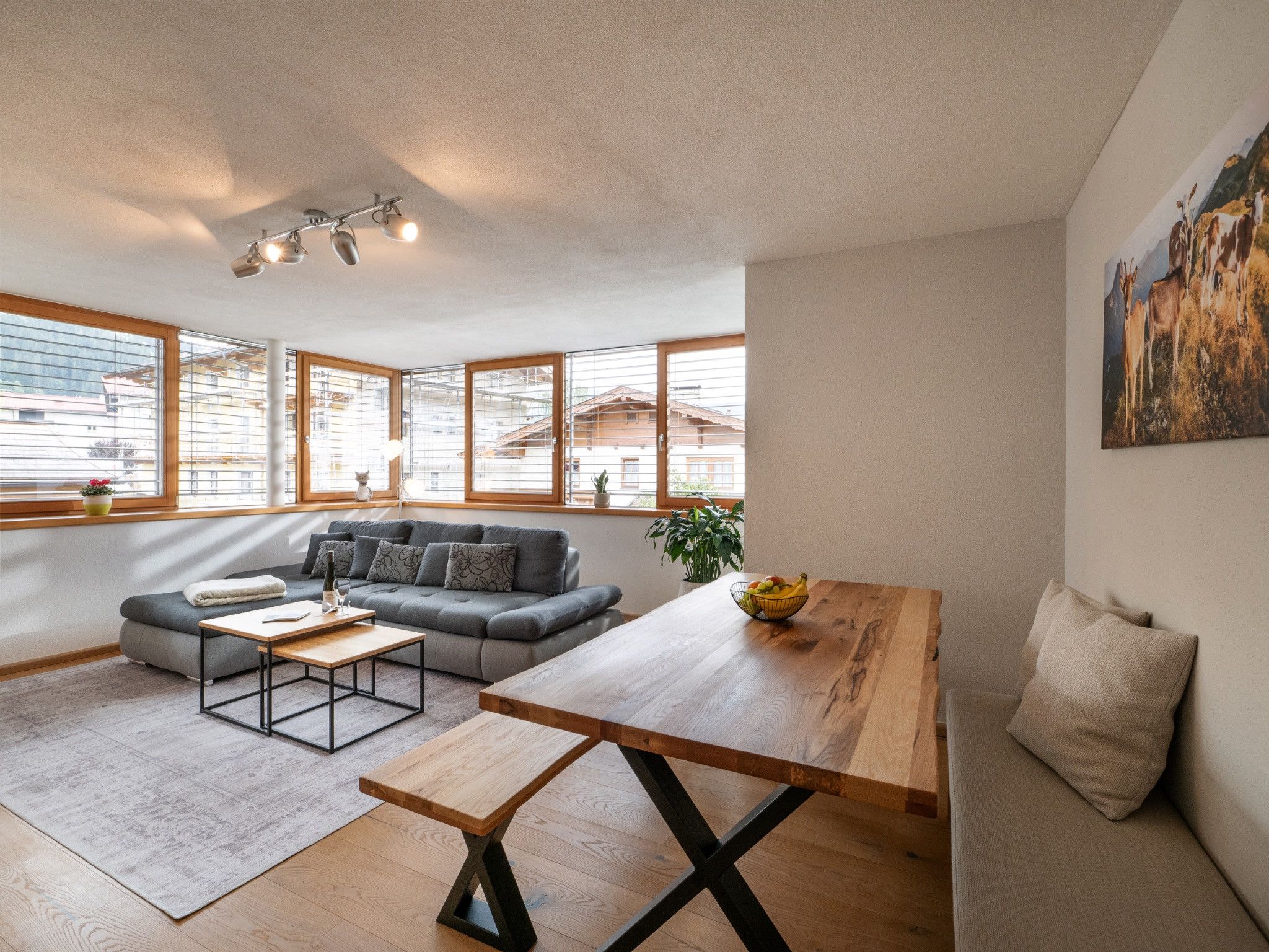 Ein modernes Wohnzimmer mit einer Couch, einem Couchtisch und einem Holzessttisch.