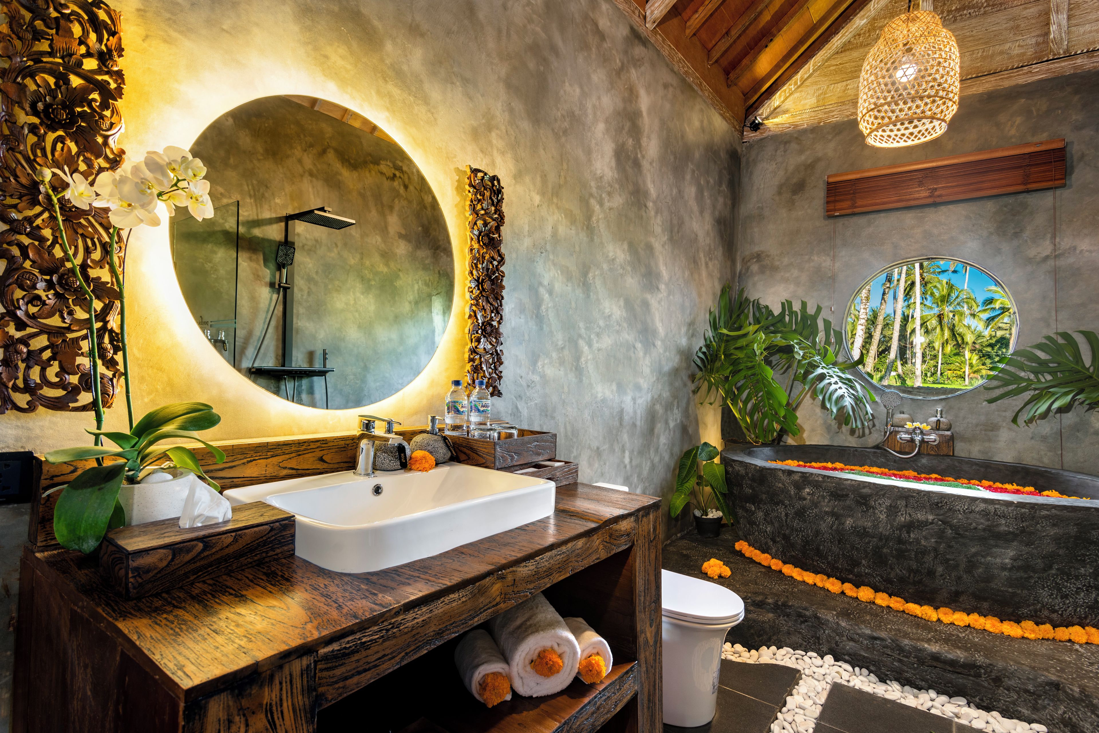 A bathroom with a large mirror, a sink, a bathtub, and a shower.