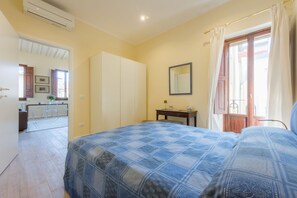 A bedroom with a bed, a wardrobe, a desk, and a window with curtains. - Apartments Florence - Mona Lisa Charme (Firenze)