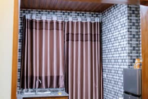 A bathroom with a sink, a mirror, and a shower curtain.
