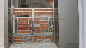 A modern building entrance with a metal gate and a tiled floor.
