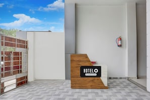 Mostrador de recepción de hotel con un cartel que indica servicio corporativo.