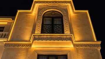 A building facade with a prominent arched window and decorative moldings.