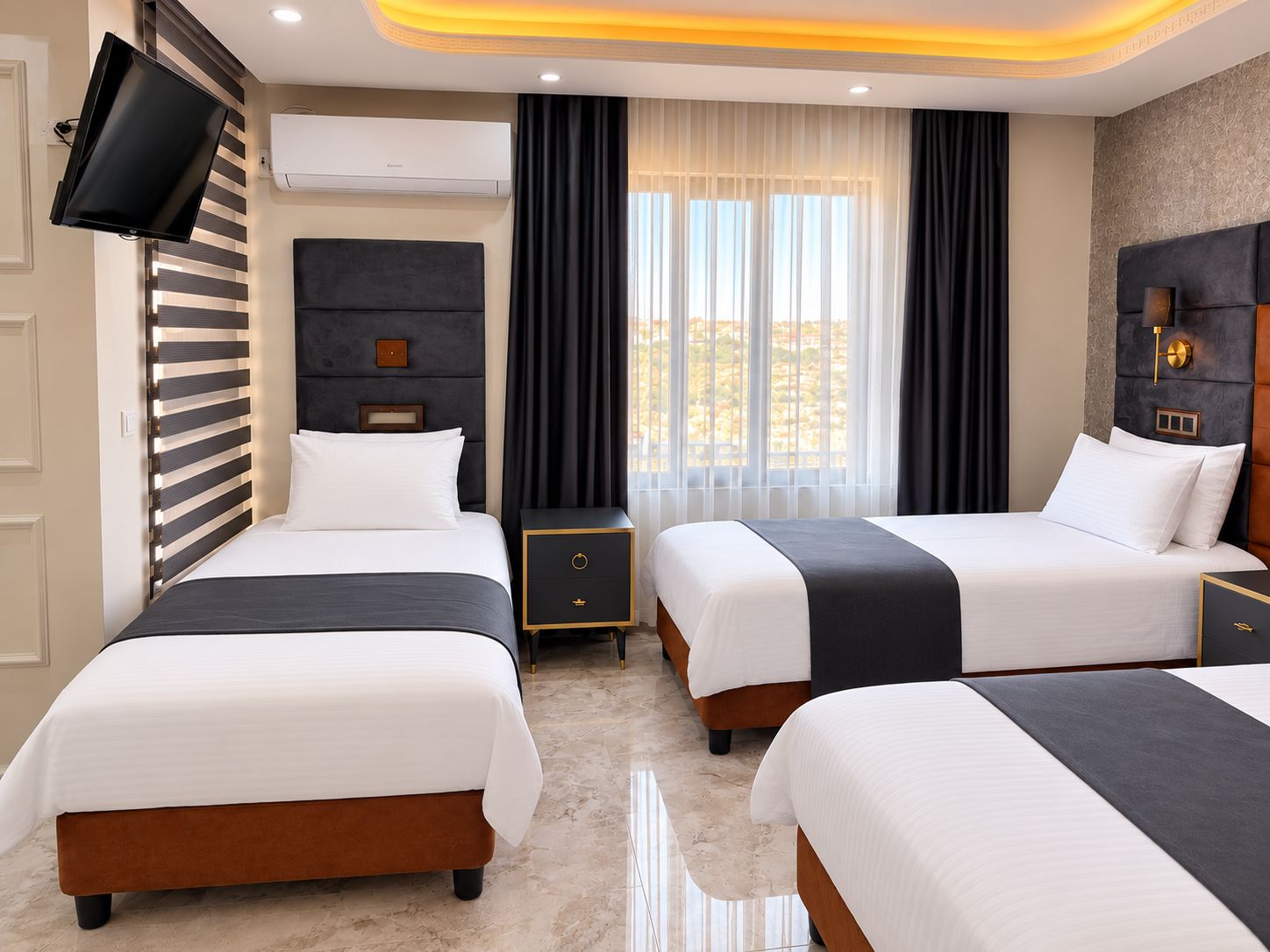 A hotel room with two beds, a flat-screen TV mounted on the wall, a large window with curtains, and a modern ceiling design.