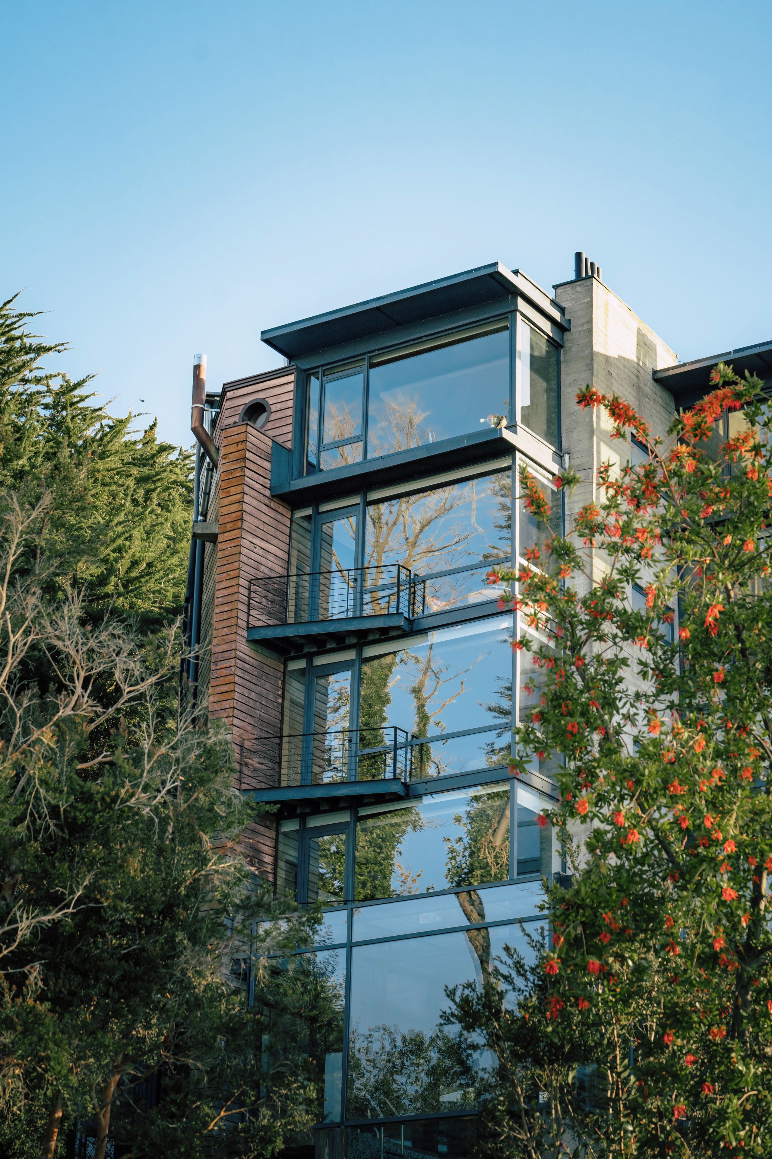 A modern building with multiple floors, large windows, and a mix of brick and glass materials.