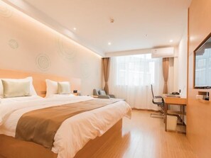 A hotel room with a large bed, a desk, and a television. - Greentree INN Zhangjiakou High Speed Railway Station (Zhangjiakou)
