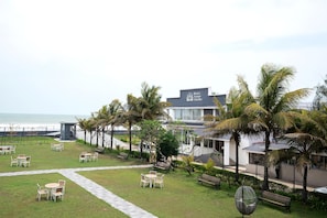 A hotel with a pool area, outdoor seating, and a view of the ocean. - Hotel Sonar Bangla Mandarmoni (Kanthi)