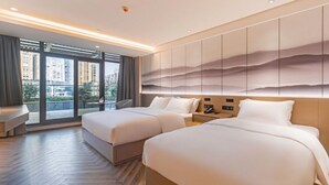 A hotel room with two beds, a large window with a city view, and a modern wall design. - Rezen Hotel Meiyo (Suining)