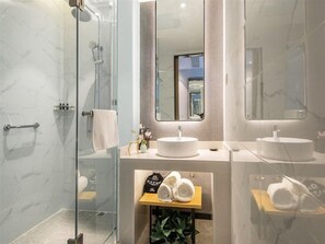 A modern bathroom with a glass shower enclosure, two sinks, and a mirror. - Magnotel (Jiaxing)