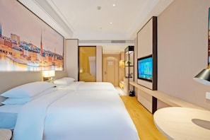A hotel room with a large bed, a television, and a painting of a cityscape. - Vienna International Hotel (Nanping)