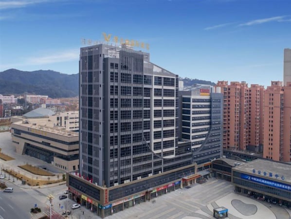 A multi-story building with a prominent sign at the top. - Vienna International Hotel (Nanping)