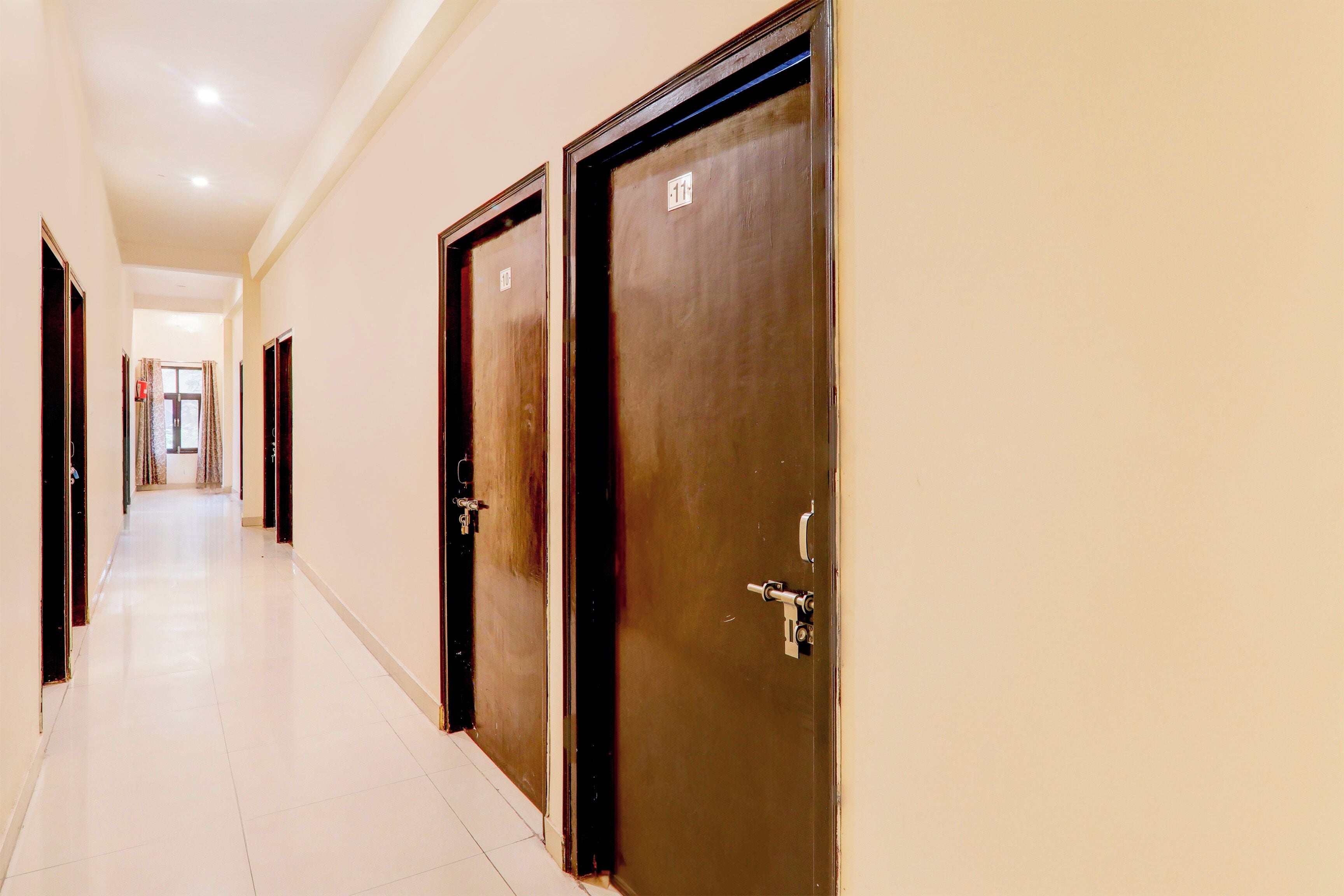 A hotel corridor with doors numbered 10 and 11, leading to rooms.