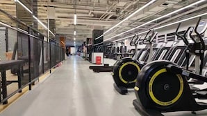 A gym with treadmills, exercise equipment, and a clean, well-lit space. - Four Seasons Apple Hotel (Beijing)