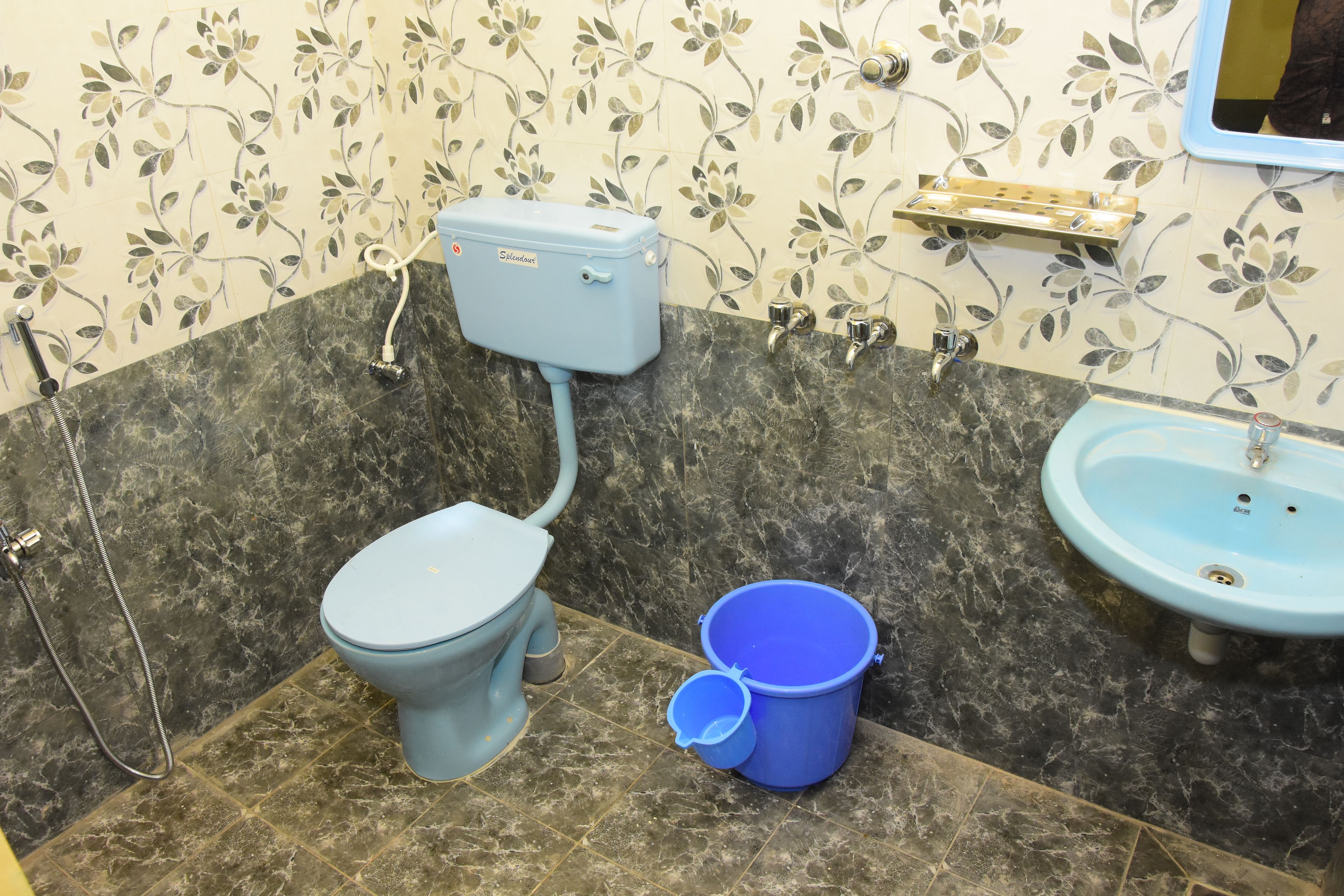 Une salle de bain avec des toilettes, un lavabo et une douche.