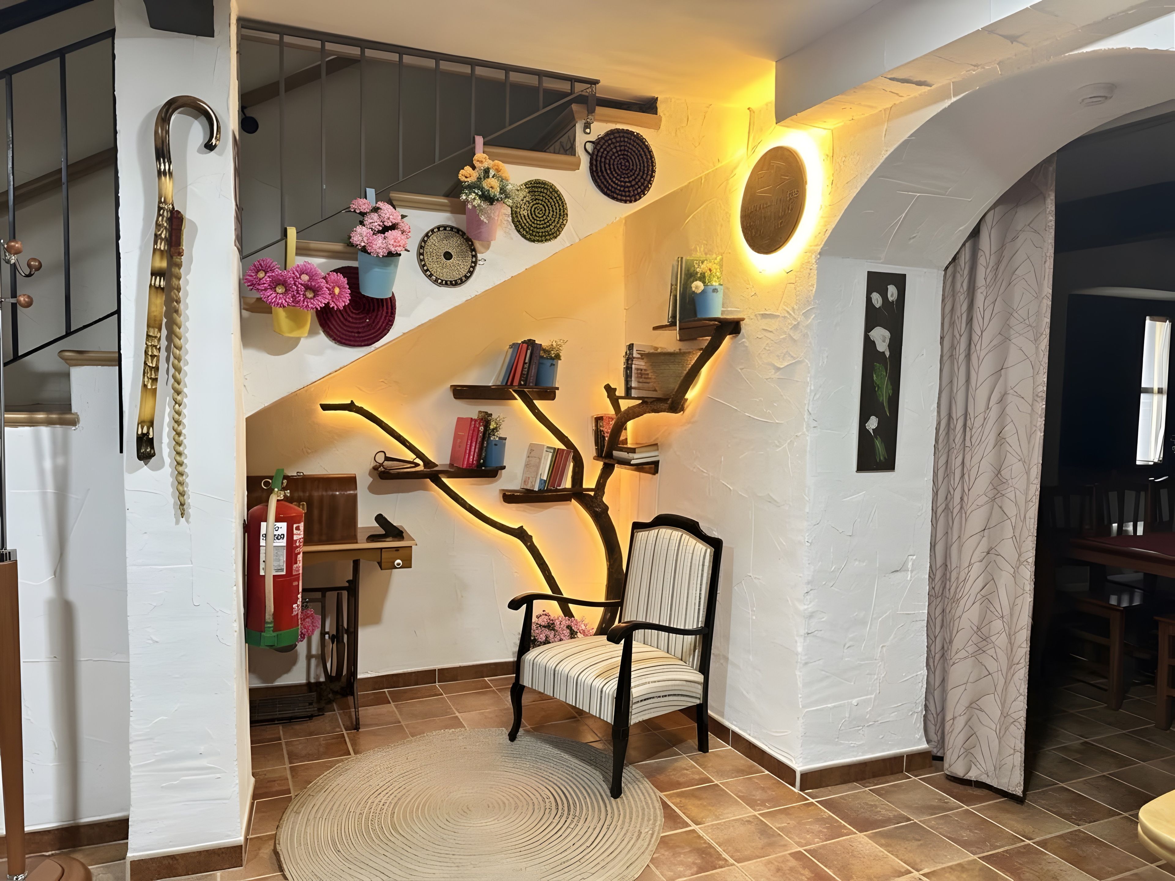 A staircase with a unique tree-like shelf design, a chair, and a fire extinguisher.