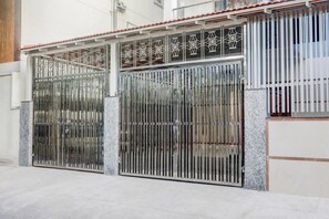 A gated entrance with a metal gate and decorative metalwork.