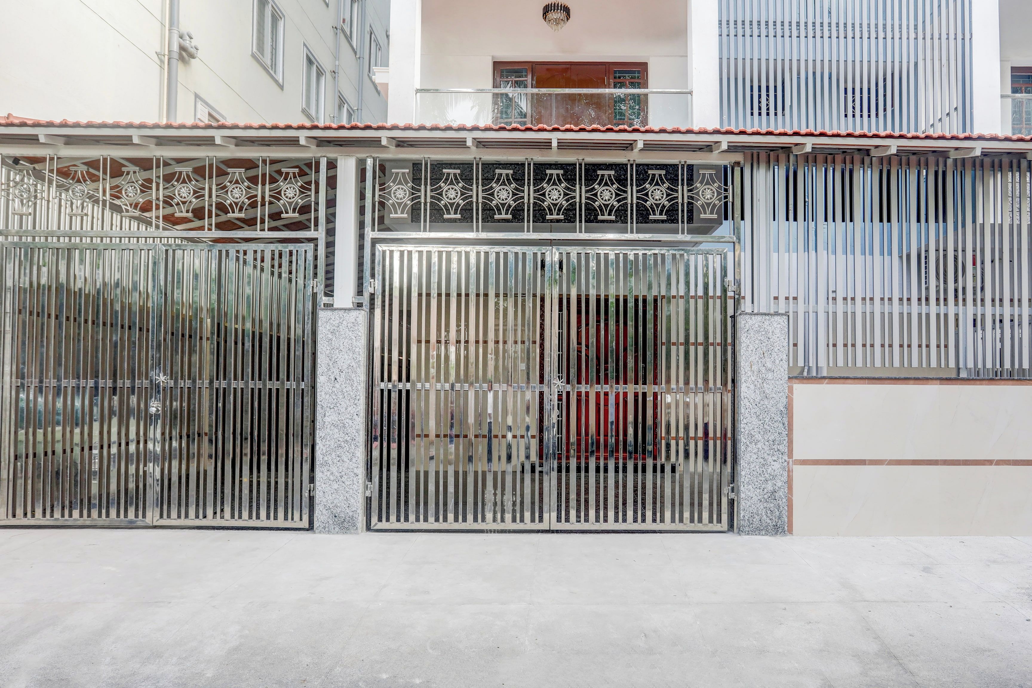 A gated entrance with a metal gate and decorative metalwork.