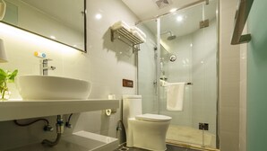 A modern bathroom with a glass-enclosed shower, a white sink, and a toilet. - 7 Days Premium (Chongqing)