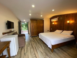 A bedroom with a bed, a desk, a television, and a wardrobe. - Astroia Pansiyon (Lapseki)