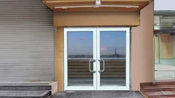 A double door entrance with a metal awning above.