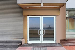 A double door entrance with a metal awning above.