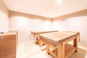 Ein Zimmer mit zwei Holztischen und einem Holzschrank.