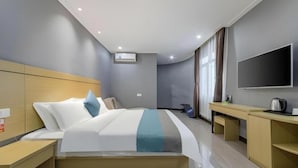 A modern hotel room with a large bed, bedside tables, a flat-screen TV, and a desk with a kettle. - Ying Feng Yuan Hotel (Guangzhou)