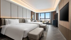 A hotel room with two beds, a large TV, a city view, and a modern design. - Wyndham Changsha Yanghu (Changsha)