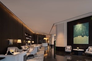 A modern lobby with seating areas, a large abstract painting, and a polished floor. - Wyndham Changsha Yanghu (Changsha)