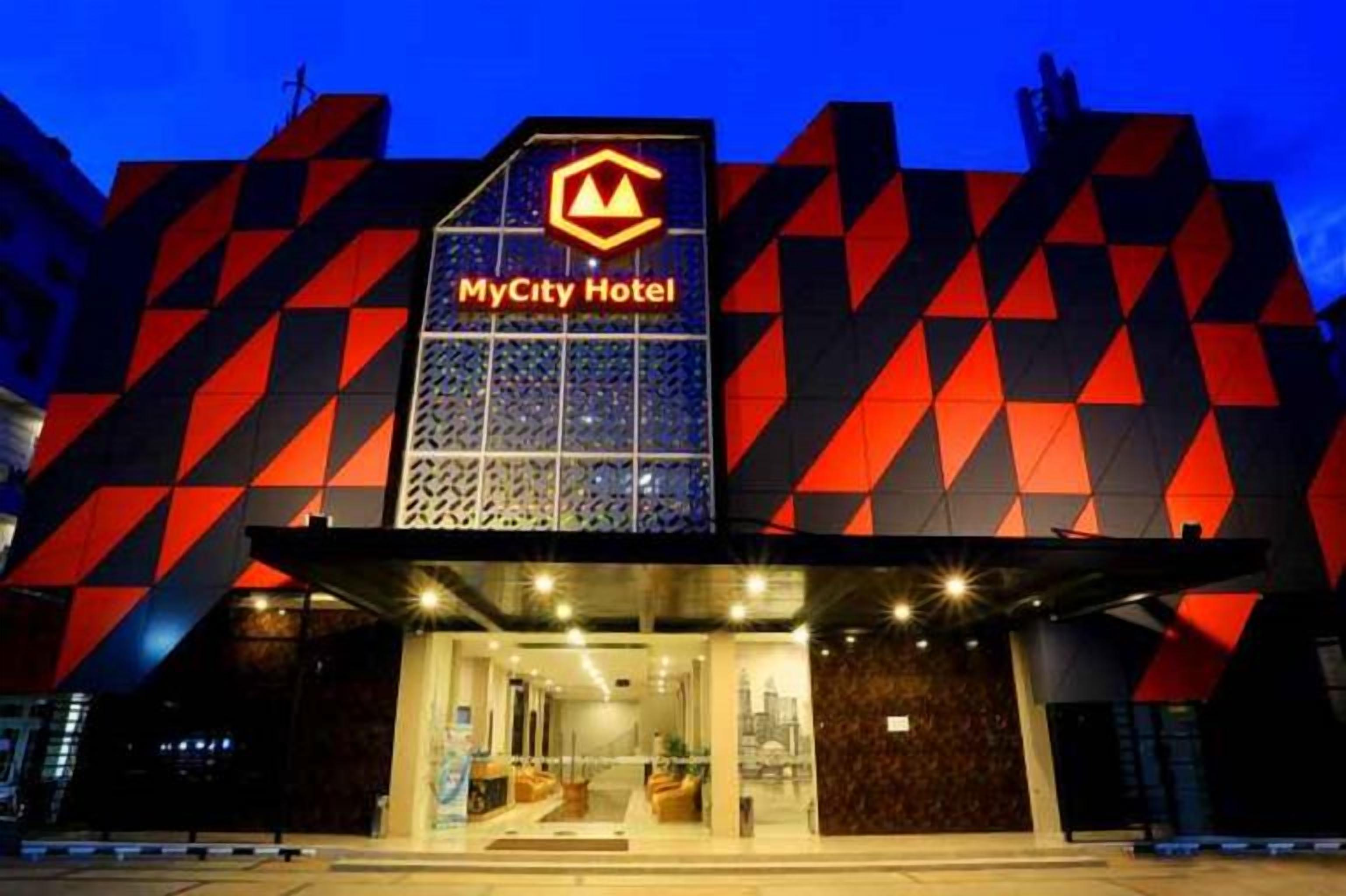 A hotel with a distinctive geometric facade and a prominent sign.
