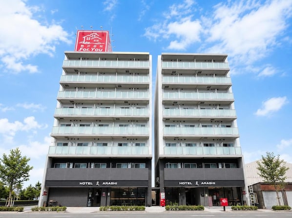 A modern hotel building with two identical structures, each featuring a prominent 'Hotel Arashi' sign at the ground level. - Hotel Arashi Nambaminami No003 (Osaka)