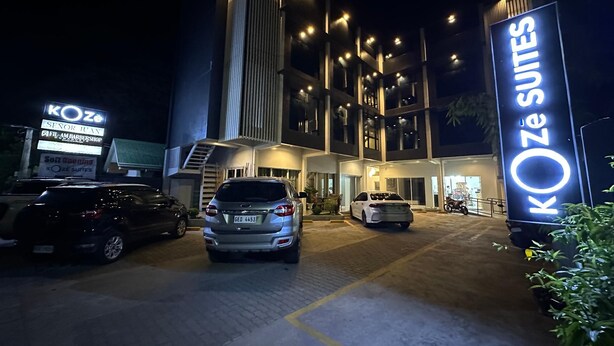 A hotel entrance with a modern design, featuring a prominent sign for KOZE SUITES. - Koze Suites (Dumaguete)